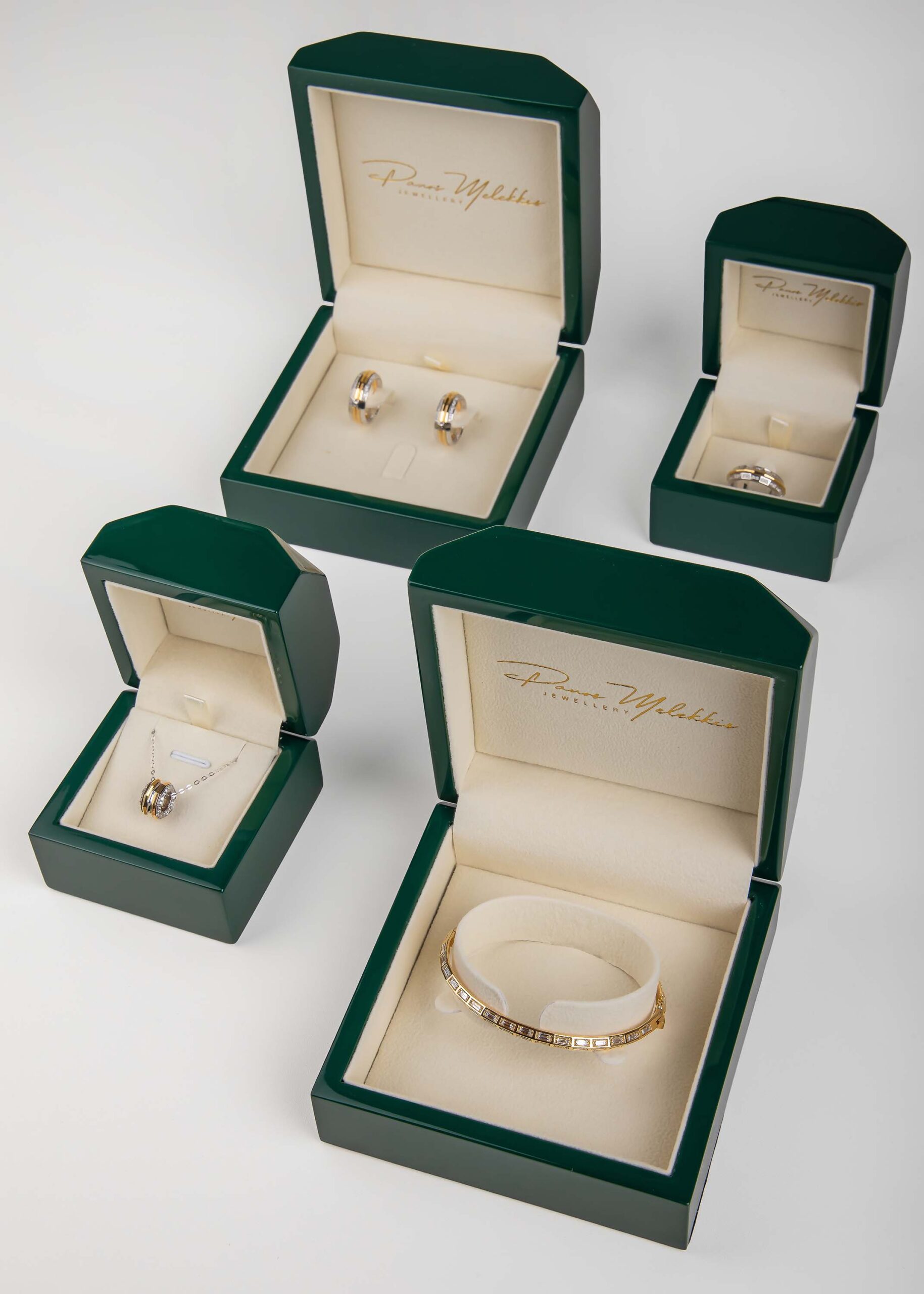 Panos Melekkis bracelet, rings, and pendant in branded green jewelry boxes