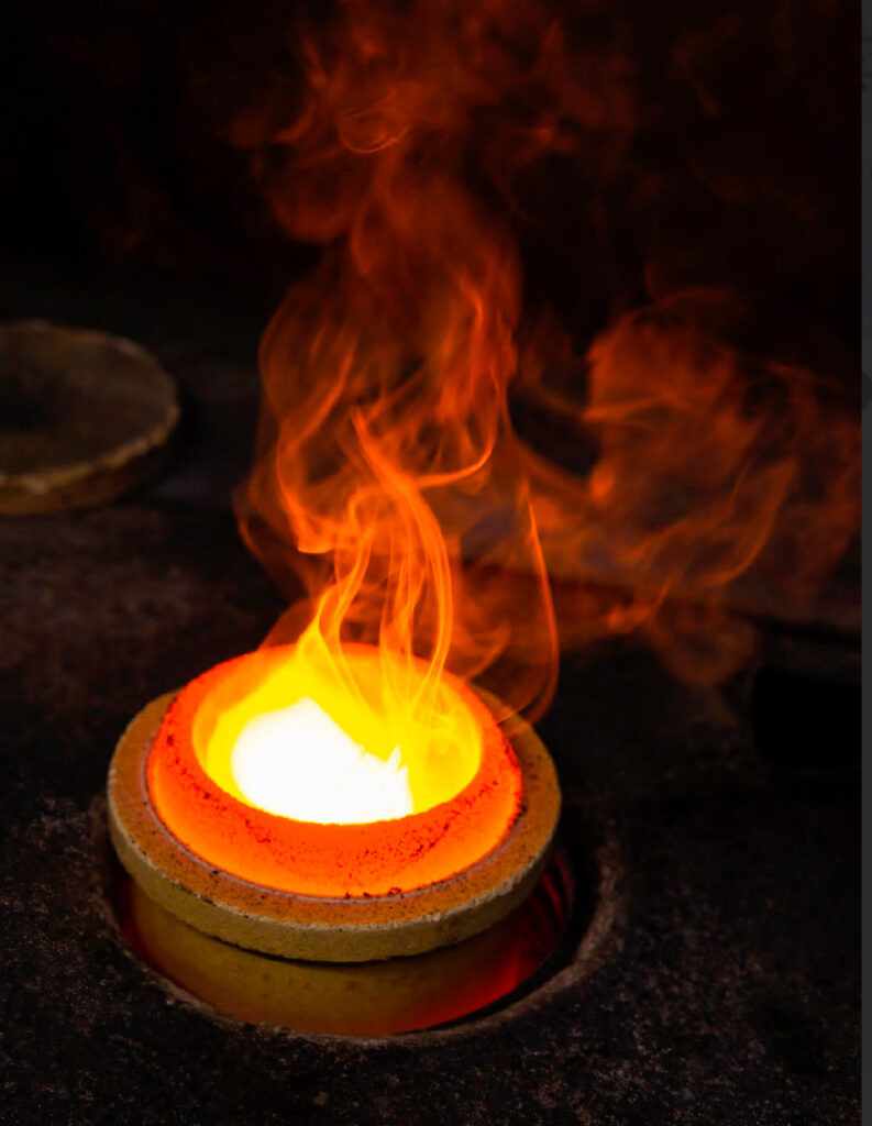 Molten gold in high-temperature crucible during jewellery production